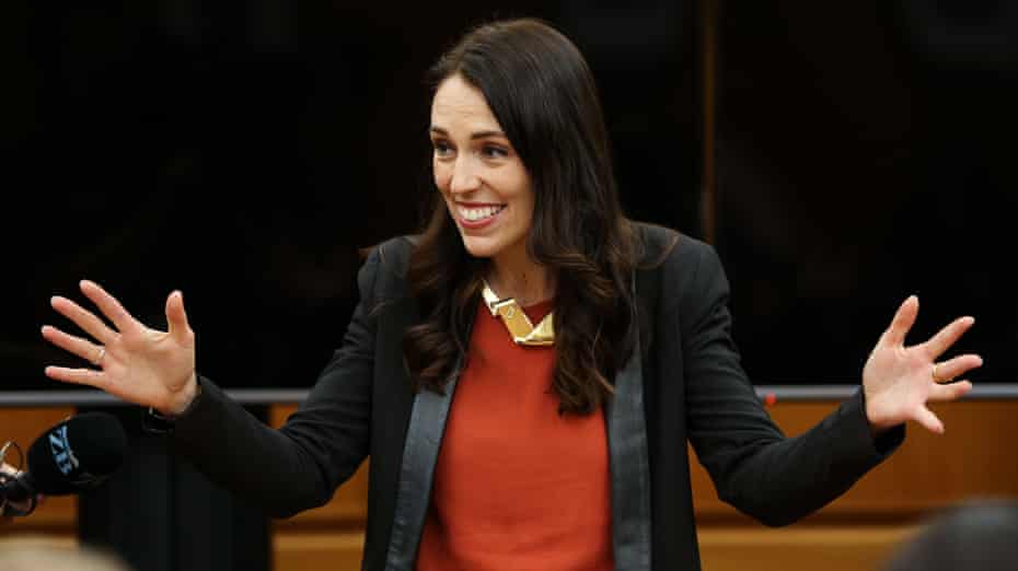 Jacinda Ardern, smiling with her arms outstretched