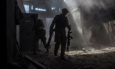 Ukrainian soldiers make their way through the  industrial area of Sievierodonetsk