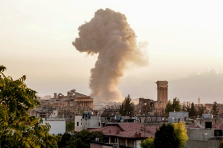 Smoke rises from among houses