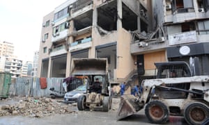 Workers clear rubble in the aftermath of what security sources said was an Israeli drone strike in Beirut's southern suburb of Dahiyeh