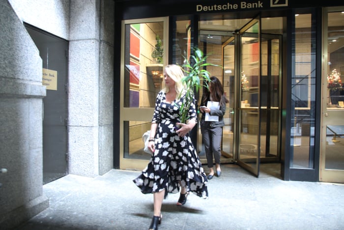 People exiting Deutsche Bank’s Manhattan headquarters with some of their belongings today