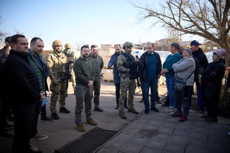 Zelenskiy speaks with local residents in a village in Kherson region.