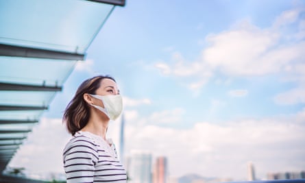 Woman wearing mask, with blue sky