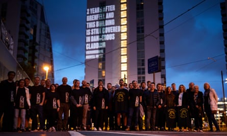 Residents gather outside NV Buildings, a block of luxury apartments at Salford Quays.