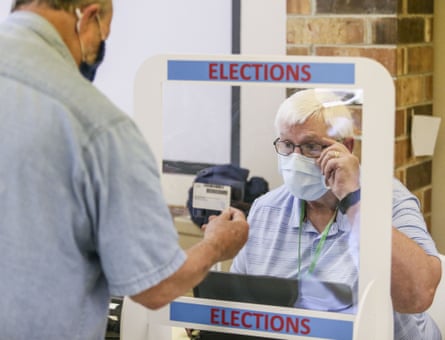 One man shows ID to another at a polling station