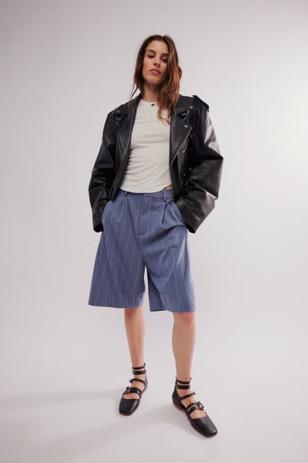 Model wearing stripe Bermuda shorts and leather jacket