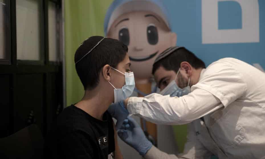 A 14-year-old Israeli receives a third booster shot of the coronavirus vaccine Jerusalem