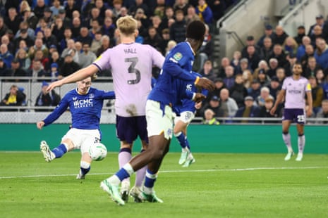 James Garner of Everton strikes the ball as opponents in purple close in during a match