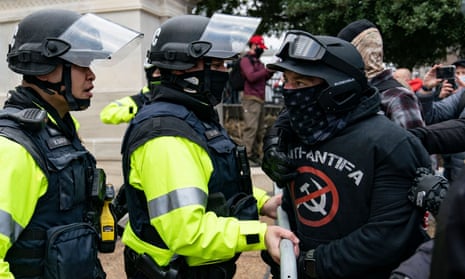 A rioter confronts police officers at the US Capitol on 6 January.