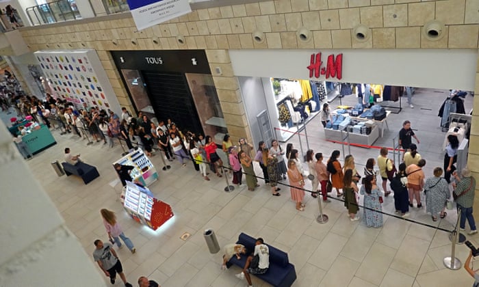 People stand in line to enter H&amp;M store in a shopping mall in Moscow, Russia. The clothing company announced in July 2022 of its decision to wind down its business in Russia due to ‘current operational challenges and an unpredictable future’. As part of this process the company reopened to sell its remaining stock. its physical stores for selling remaining stock in Russia. Earlier, in March 2022 the company paused all sales in Russia, being among some other brands which announced the suspension or limitation of their business in Russia as the result of sanctions imposed by the West on Russia in response to what the Russian President declared as a ‘Special Military Operation’ in Ukraine. Russian troops entered Ukraine on 24 February 2022, prompting a series of severe economic sanctions imposed by Western countries on Russia. EPA/MAXIM SHIPENKOV