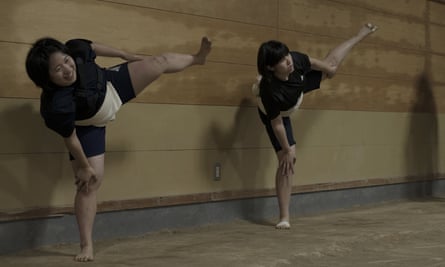 Two members of the Asahi University women sumo team go through their routine training, practicing Shiko, or foot stomping.