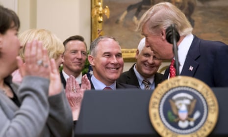 President Donald Trump shakes hands with Environmental Protection Agency (EPA) Administrator Scott Pruitt, before signing the Waters of the United States executive order, which directs the EPA to withdraw the rule that expands the number of waterways that are federally protected under the Clean Water Act.