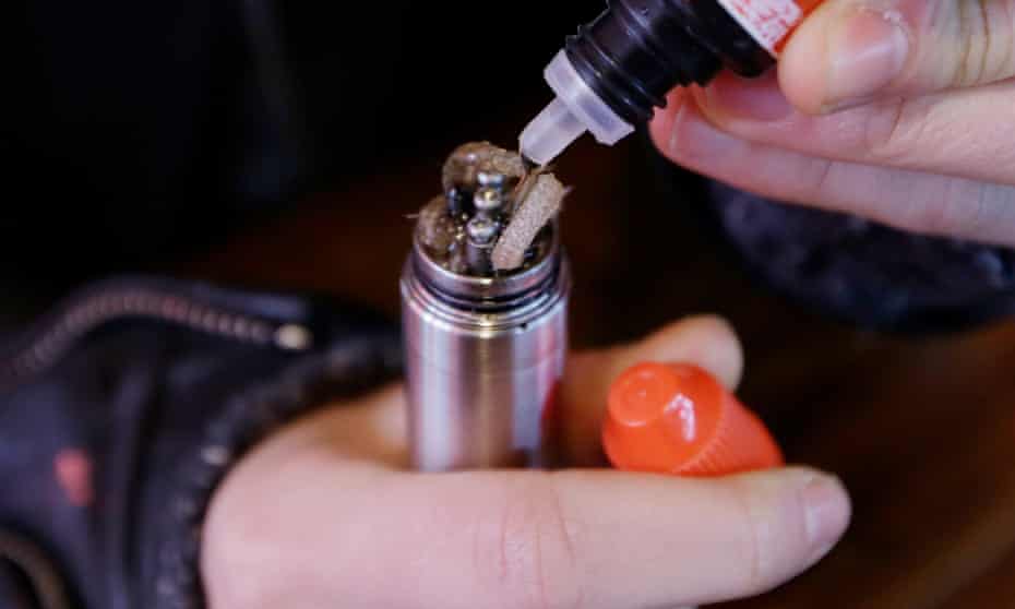 Liquid nicotine solution is poured into a vaping device