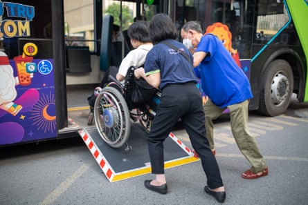 Medewerkers van VinBus, het enige bedrijf in de hoofdstad dat toegankelijkheidshellingen aanbiedt, helpen Luu aan boord van een bus.