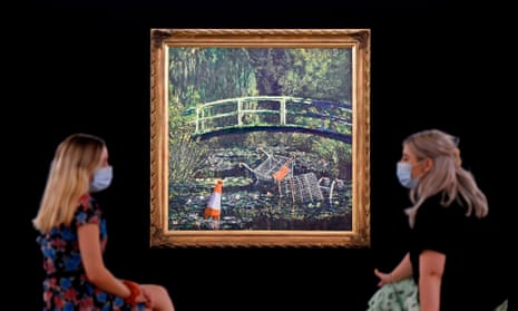 Employees wearing face masks pose with Show me the Monet by the artist Banksy.