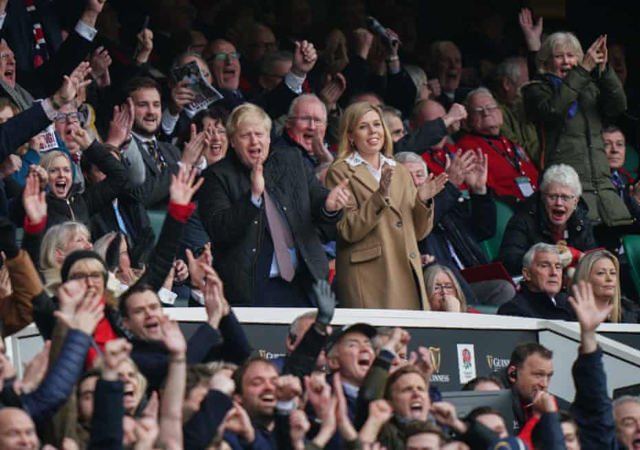 Boris Johnson and his partner, Carrie Symonds, watch England v Wales at Twickenham on 7 March, six days before sport was halted