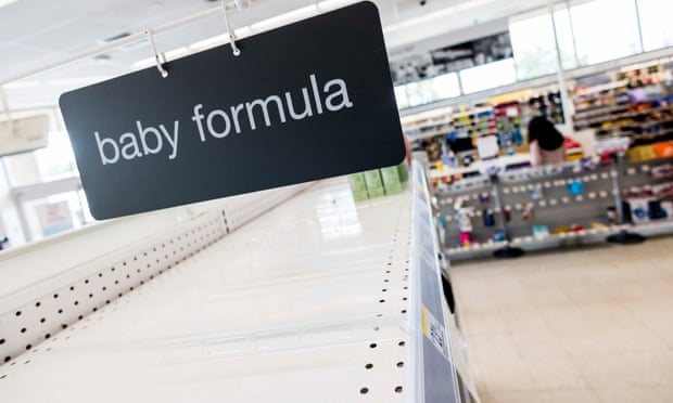 A sign for baby formula over an empty shelf in a store in Perth Amboy, New Jersey