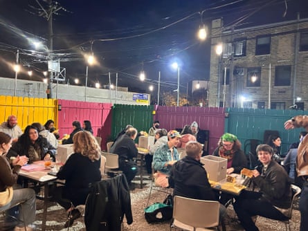 people sitting at tables and making zines