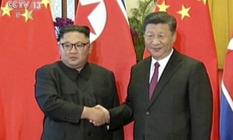Kim Jong-un and Xi Jinping shake hands in the Great Hall of the People in Beijing. 