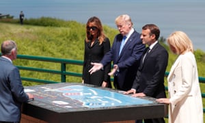 From left: Melania Trump, President Trump, President Macron and Brigitte Macron inspect a map during D-Day celebrations in Normandy.