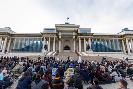 People gather for a protest calling for the resignation of the prime minister on 20 May.