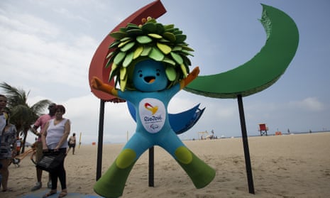 Tom, the mascot of the Rio Paralympics, jumps in front of the sculpture of Agitos, symbol of the Games, on Copacabana beach.