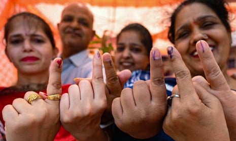 Voters show their index fingers marked with indelible ink after casting their ballots to vote at a polling station in Amritsar on 1 June 2024, during the seventh and final phase of voting in India’s general election.