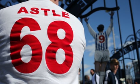 A fan at the Jeff Astle gates at the Hawthorns in a shirt honouring the FA Cup won in 1968 by the striker and his West Brom teammates.