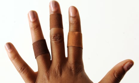 A hand with medical sticking plasters that match different skin tones 