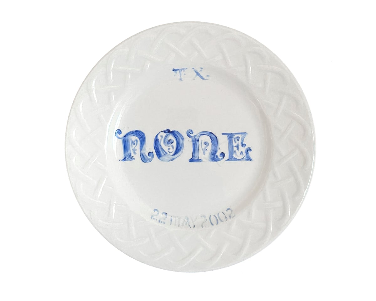 White plate with the word “none” painted in the center