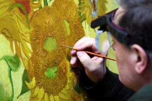 Amsterdam, Netherlands A renovator works on Van Gogh’s Sunflowers