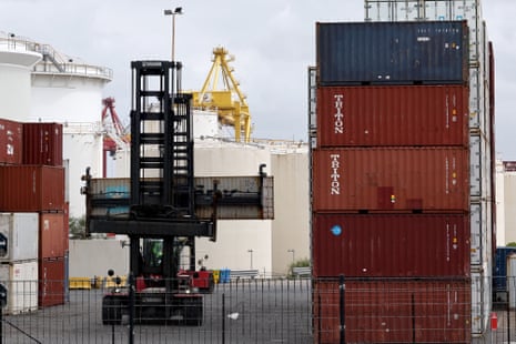A worker moving containers at the compound of ports operator DP World at Port Botany in Sydney today.