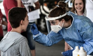 A public health worker collects a swab sample from a boy to test for Covid-19 at the Greek-Bulgarian border crossing in Promachonas on 10 July.