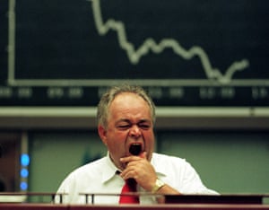 A trader yawns on the Frankfurt stock exchange.