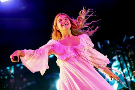 she wears a floating white low-cut dress that looks like a nightgown.