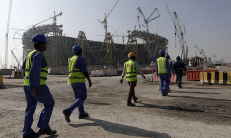 Workers walk to the Lusail Stadium, one of the 2022 World Cup stadiums in Qatar.