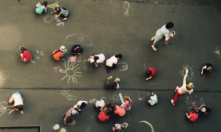 Directly above shot of children drawing on playground