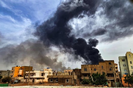 Black smoke rises from a warehouse in Khartoum