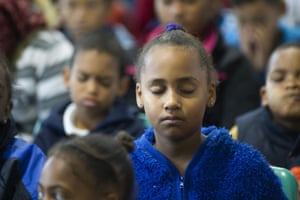 South African children at Rosewood Primary school take part in a free meditation class, in Bonteheuwel, a Cape Town suburb with significant gang problems.