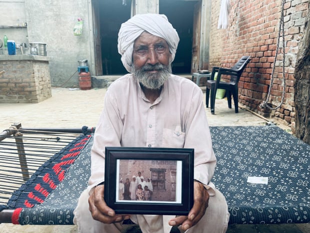Sikka Khan holding a picture of his brother Sadiq.
