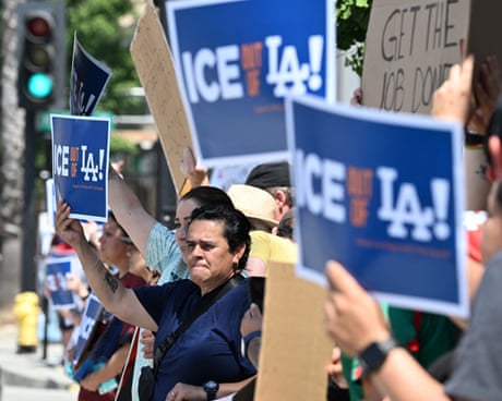 Protestors holding signs reading ‘ICE out of LA!’ Protestors holding signs reading ‘ICE out of LA!’
