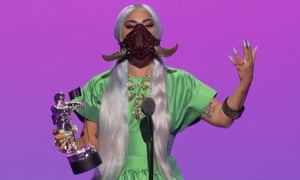 Lady Gaga accepting the award for Song of the Year in a horned mask.