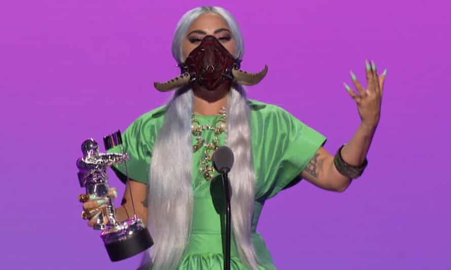 Lady Gaga accepting the award for Song of the Year in a horned mask.