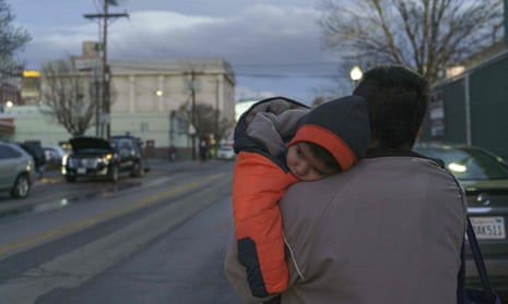 Augusto Mendoza from Guatemala and his sick one-and-a-half-year-old son Dillon head for the Greyhound bus station in El Paso on 26 December after spending five days in detention.