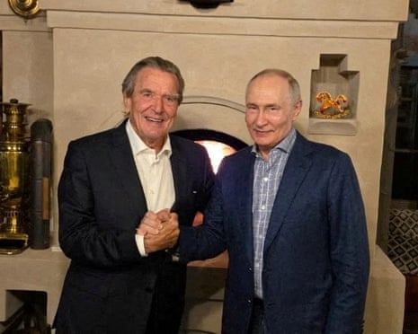 Russian president Vladimir Putin shakes hands with former German chancellor Gerhard Schröder during what the Kremlin described as a meeting at Putin's residence on the day of his 74th birthday, at an unidentified location in Russia.