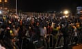 A crowd outside a French army base at night in Niamey