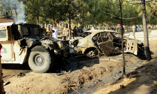 Vehicles damaged by a suicide bomb attack in Helmand
