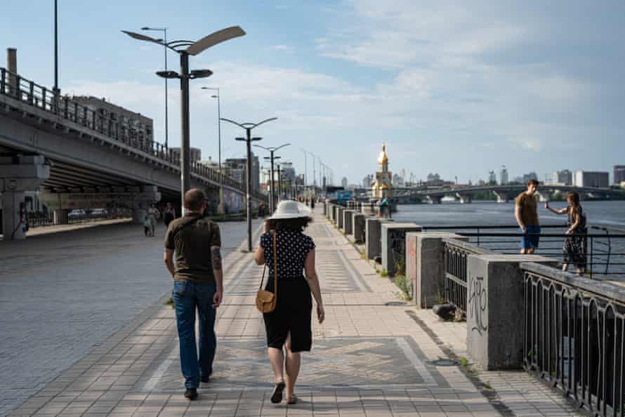 A couple walks along the Dnipro river embankment on June 12 in Kyiv, Ukraine.