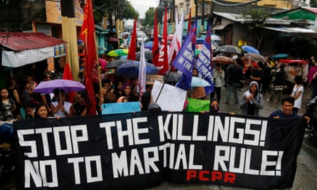 Protesters hold placards and a banner calling for justice for student Kian Loyd delos Santos at a wake in Kaloocan city, north of Manila.