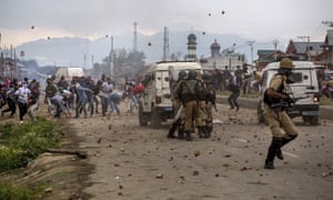 Kashmiri protesters throw stones and bricks at Indian paramilitary soldiers during a protest on the outskirts of Srinagar